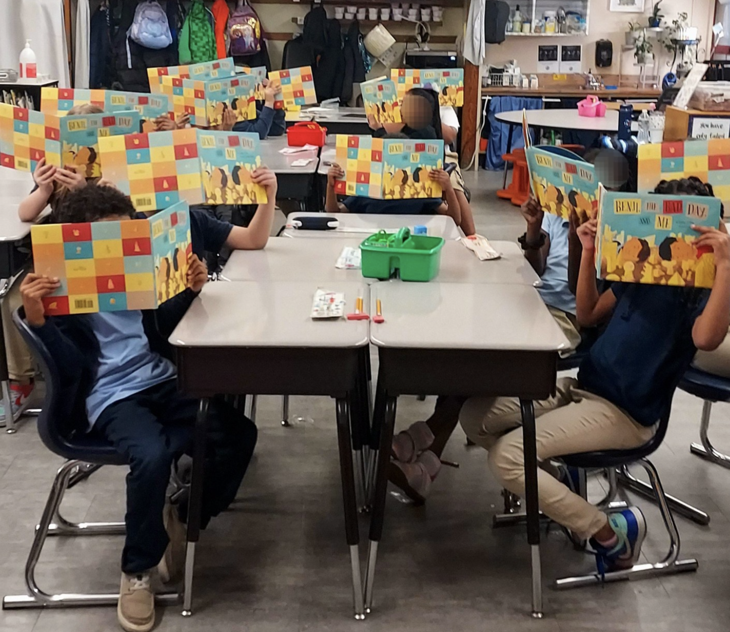 a cute funny picture of a classroom of kids, all holding copies of Benji, The Bad Day, and Me in front of their faces!